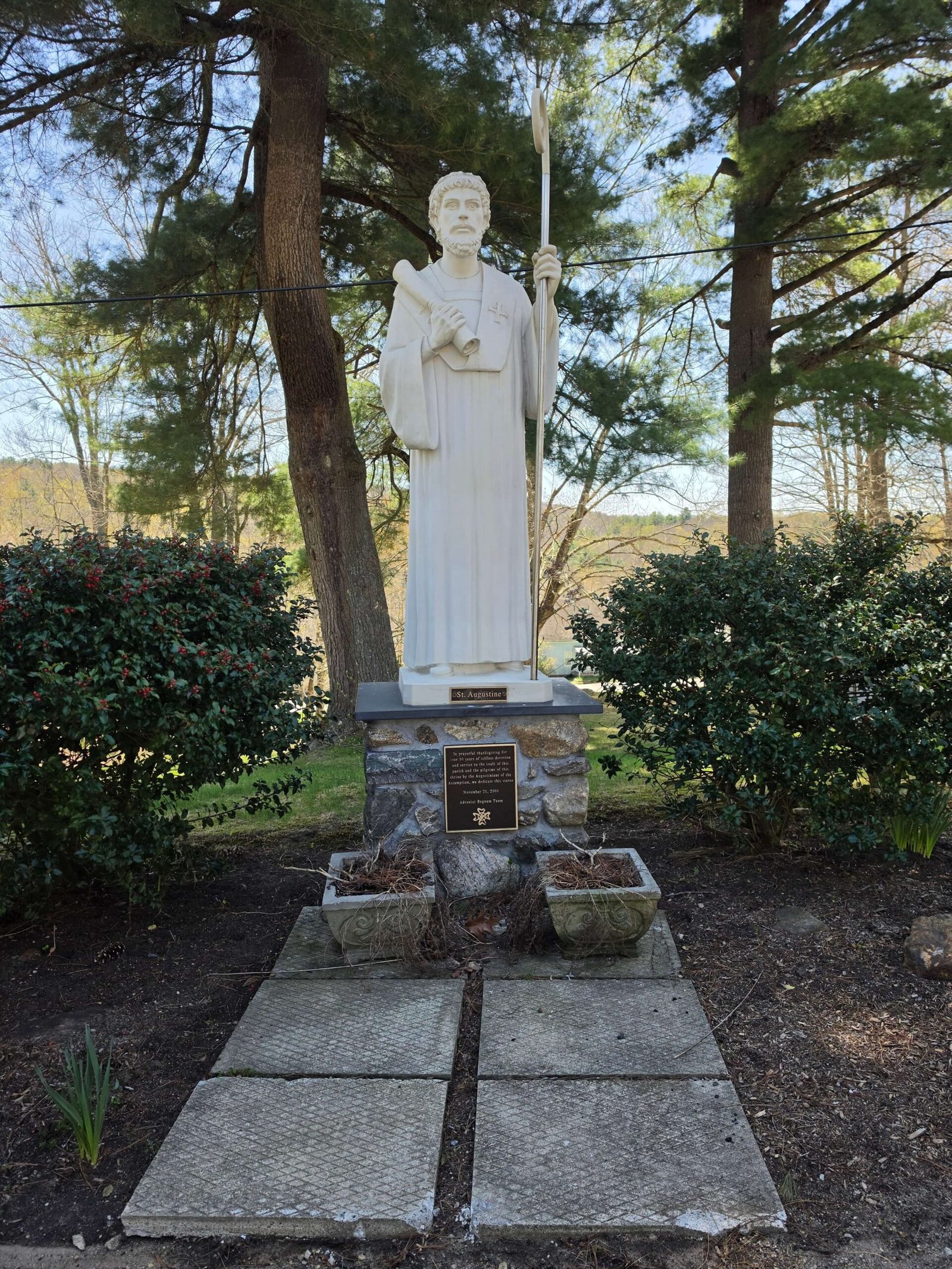 A statue of St Augustine holding a staff and a scroll